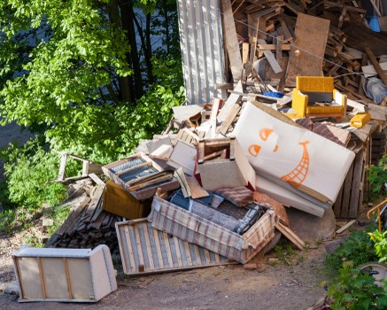 Risk assessment checklist and site survey markings near a skip